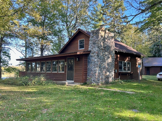 log cabin with a front lawn