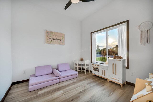 sitting room with ceiling fan and light hardwood / wood-style flooring