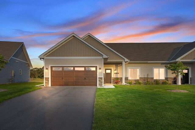 craftsman-style home with a lawn and a garage