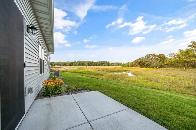 view of yard featuring a patio and central AC unit