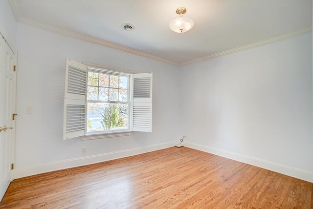 spare room with crown molding and wood-type flooring