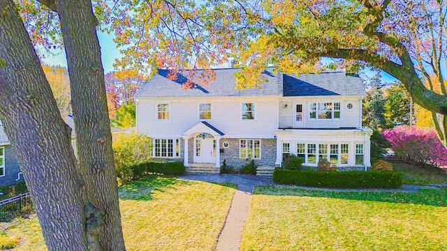 colonial-style house with a front lawn