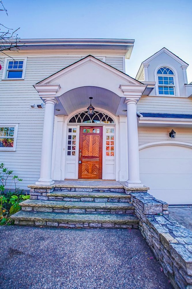 view of exterior entry with a garage