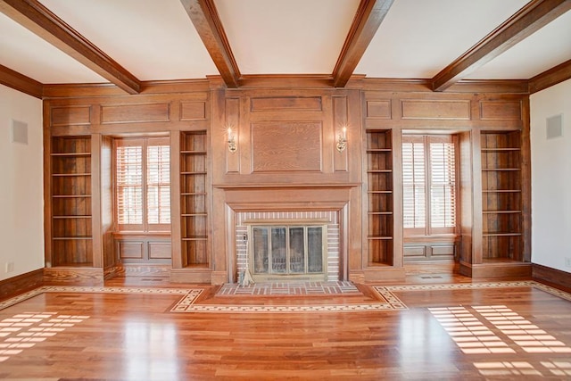 unfurnished living room with built in features and a wealth of natural light