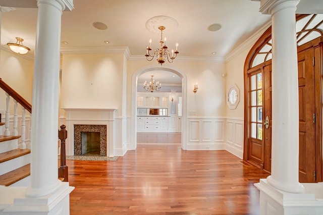 interior space with hardwood / wood-style flooring, crown molding, and a notable chandelier