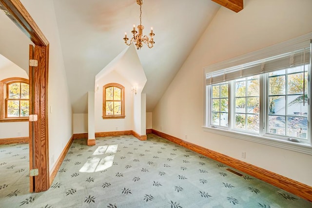 bonus room with lofted ceiling with beams, light colored carpet, and a chandelier