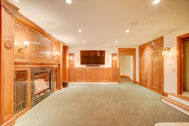 unfurnished living room featuring carpet flooring and a fireplace