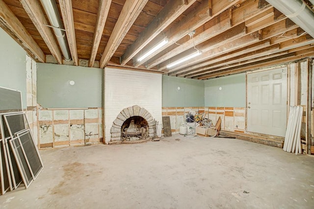 basement featuring a brick fireplace