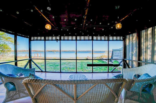 sunroom / solarium with a water view