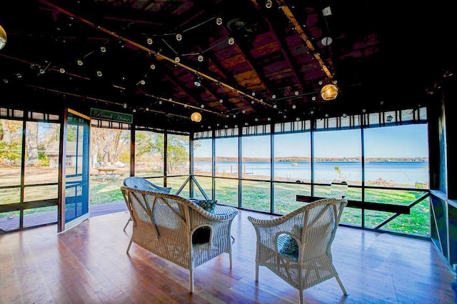 sunroom / solarium with a water view and lofted ceiling