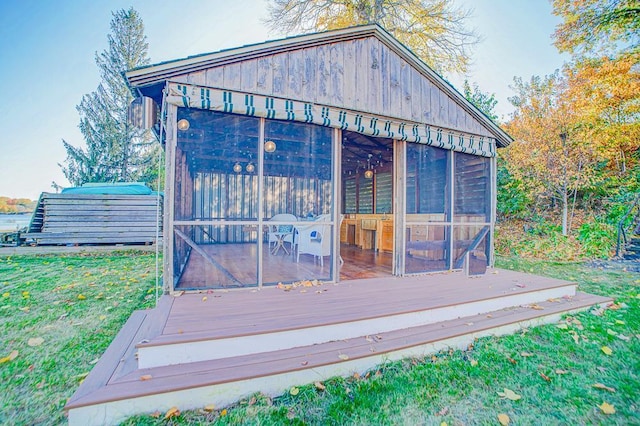 wooden terrace with a lawn