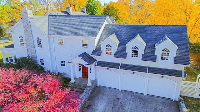 new england style home featuring a garage