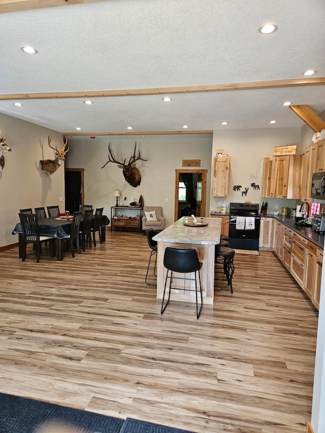 interior space featuring a textured ceiling, light hardwood / wood-style floors, and sink