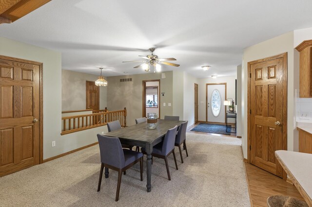 dining space with light hardwood / wood-style floors and ceiling fan