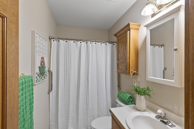 bathroom featuring toilet, a shower with curtain, and vanity