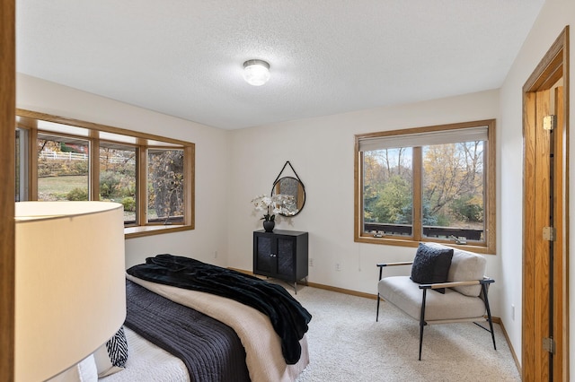 carpeted bedroom featuring a textured ceiling