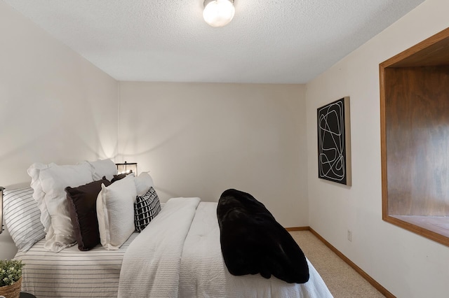 bedroom with carpet and a textured ceiling