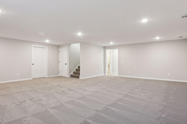 basement featuring light carpet