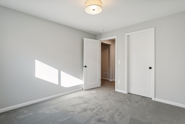 unfurnished bedroom with a closet and carpet floors