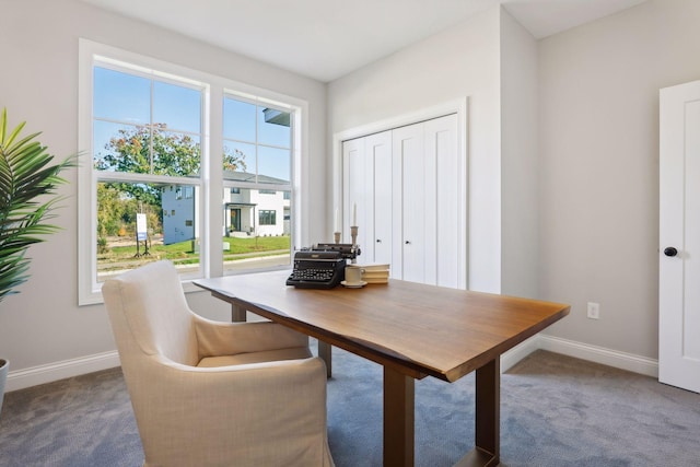 dining room featuring dark colored carpet