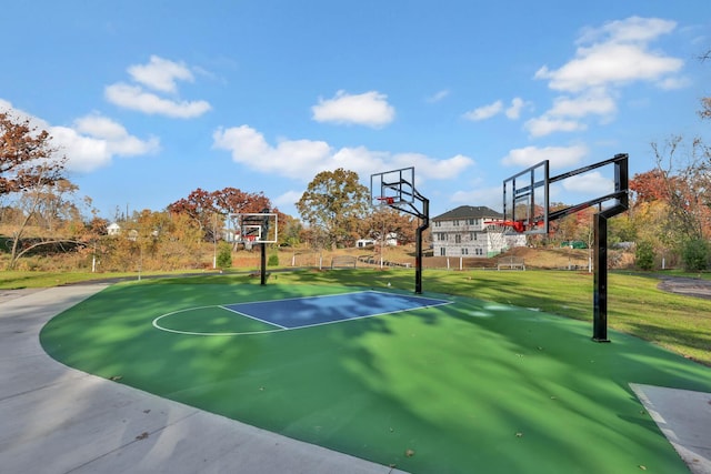 view of basketball court featuring a yard