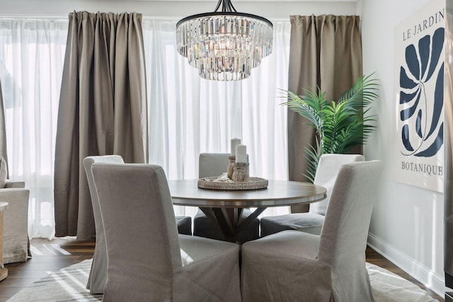 dining area with hardwood / wood-style flooring and a chandelier