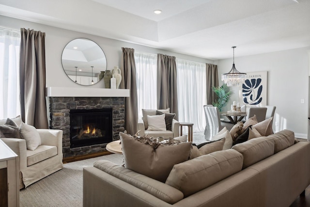 living room featuring a fireplace and a notable chandelier