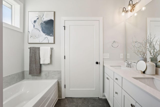 bathroom featuring a washtub and vanity