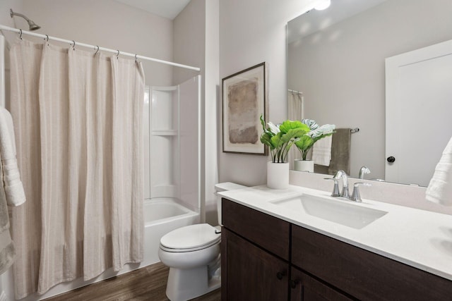 full bathroom with toilet, wood-type flooring, vanity, and shower / tub combo with curtain