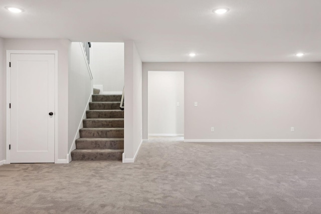 basement featuring light carpet