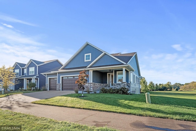 view of front of property with a garage, a porch, and a front lawn