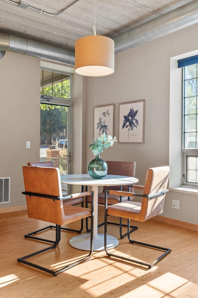 dining room with light hardwood / wood-style flooring and plenty of natural light