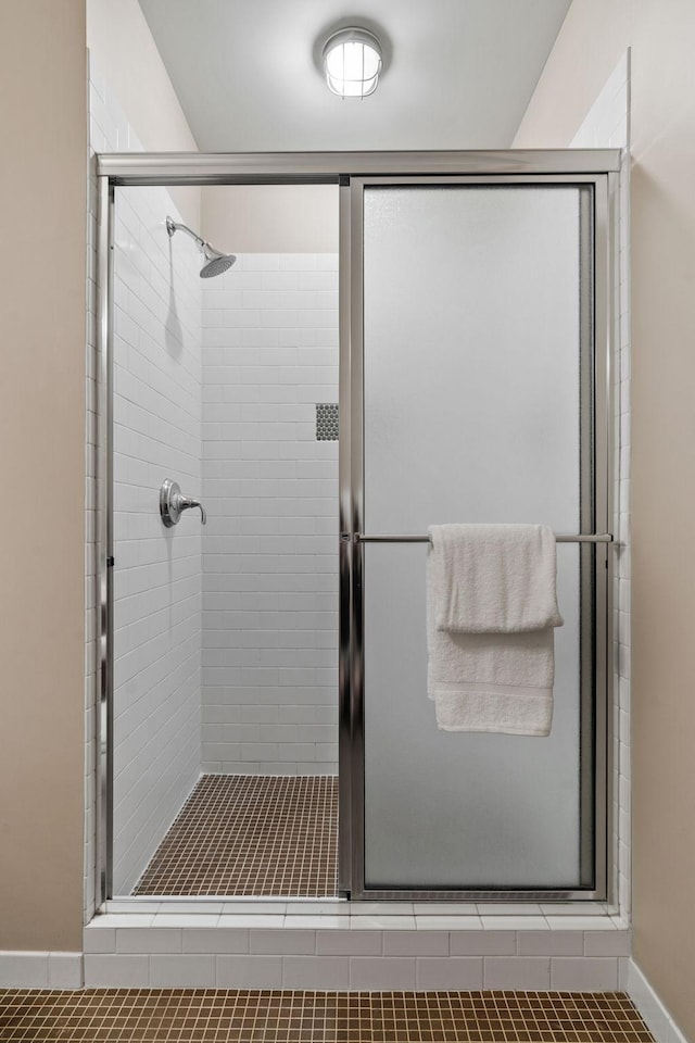 bathroom featuring a shower with door and tile patterned floors