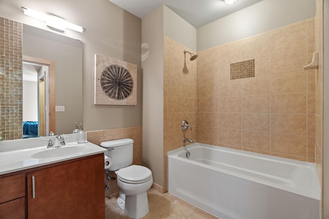 full bathroom featuring tiled shower / bath, vanity, tile patterned flooring, and toilet