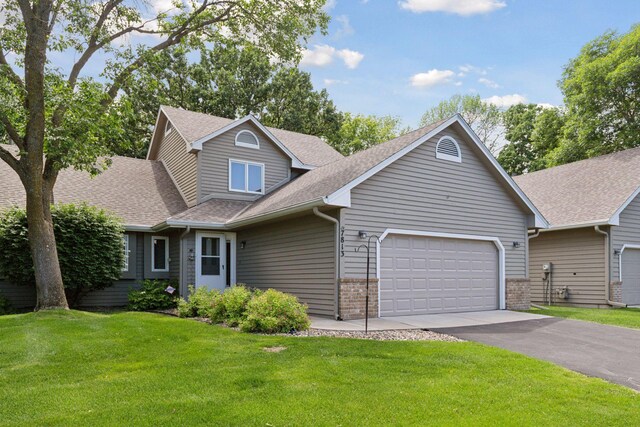 view of front of home with a front yard and a garage