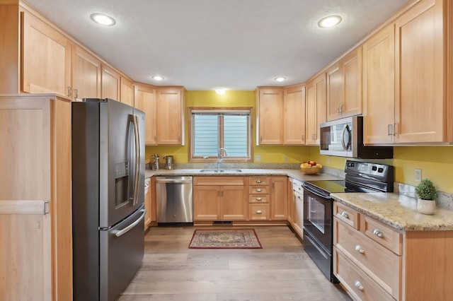 kitchen featuring sink, stainless steel appliances, and light brown cabinetry