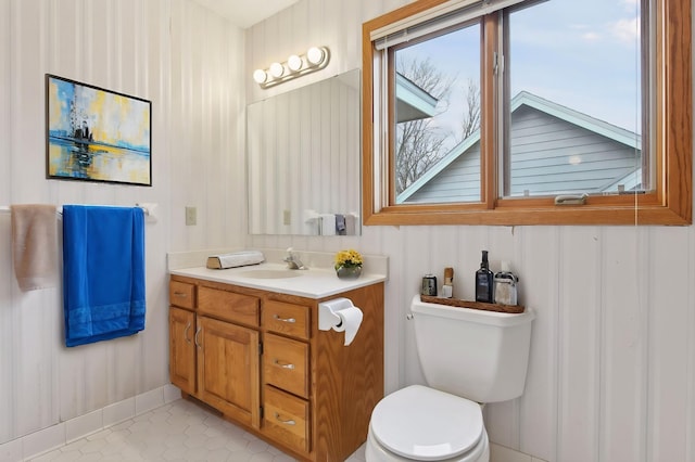 bathroom featuring toilet, vanity, and tile patterned floors