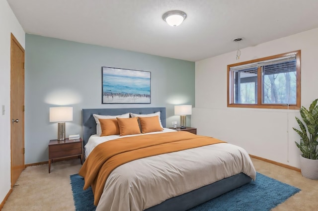 bedroom with baseboards, visible vents, and light colored carpet