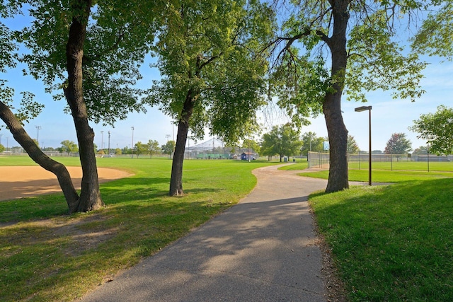 view of community with a lawn and fence