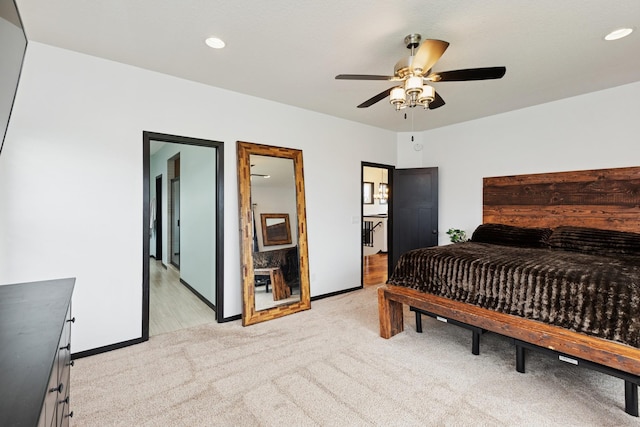 bedroom with baseboards, light carpet, and recessed lighting