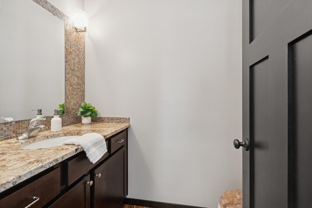 half bathroom with tasteful backsplash and vanity