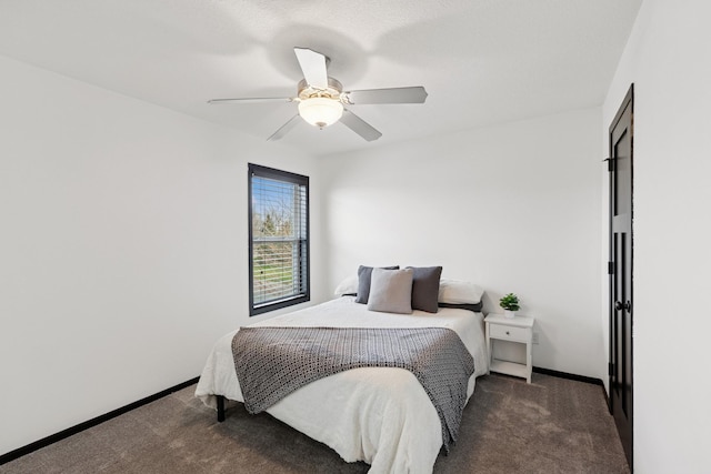carpeted bedroom featuring baseboards and ceiling fan