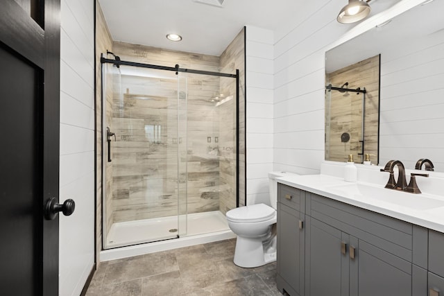 full bathroom featuring vanity, recessed lighting, toilet, and a shower stall