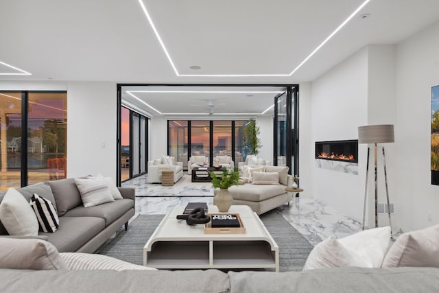1225 Shoreline Dr, Orono, MN 55391 - living room featuring a glass covered fireplace and ceiling fan