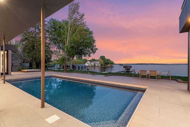1225 Shoreline Dr, Orono, MN 55391 - pool at dusk featuring a patio, an outdoor pool, and a water view