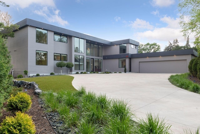 1225 Shoreline Dr, Orono, MN 55391 - contemporary home with concrete driveway, a garage, and a front lawn