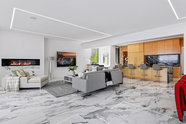 1225 Shoreline Dr, Orono, MN 55391 - living area with light marble finish floors and a glass covered fireplace