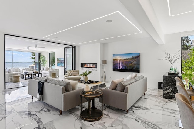 1225 Shoreline Dr, Orono, MN 55391 - living area featuring healthy amount of natural light, a wall of windows, light marble finish flooring, and a water view
