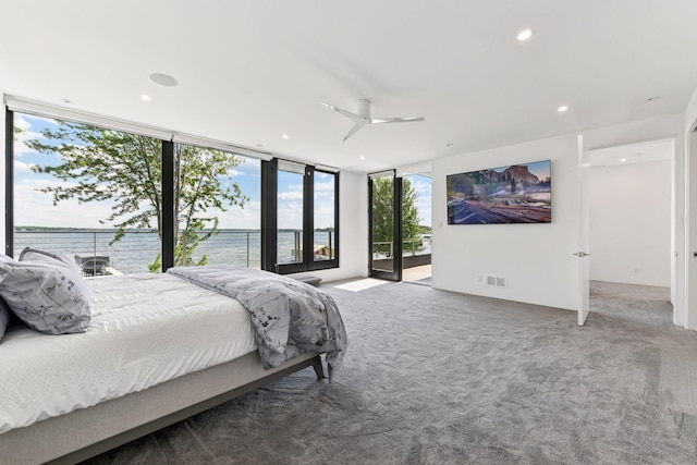1225 Shoreline Dr, Orono, MN 55391 - carpeted bedroom featuring access to outside, a water view, a wall of windows, recessed lighting, and ceiling fan