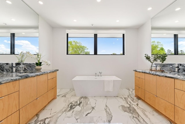1225 Shoreline Dr, Orono, MN 55391 - full bath with healthy amount of natural light, two vanities, recessed lighting, and a freestanding tub